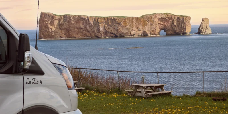 Fourgon aménagé et table de pique-nique sur la côte face au rocher Percé, au Québec